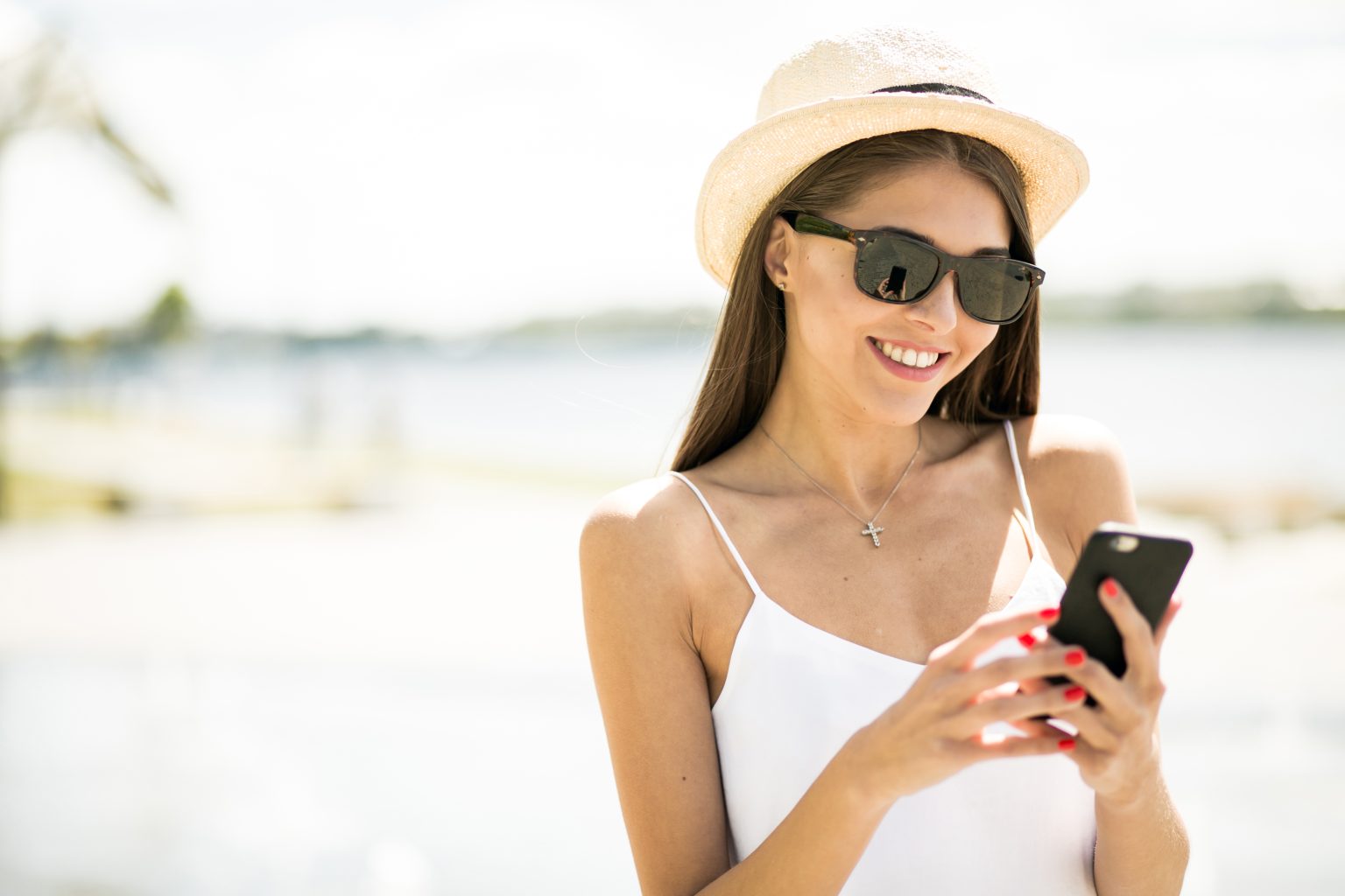 smiling woman looking at her phone