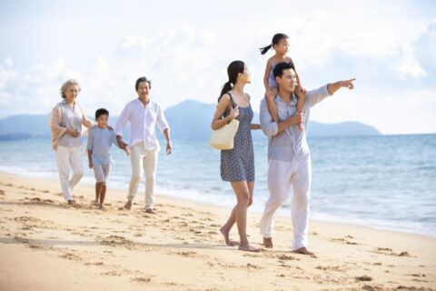family-walking-at-the-beach