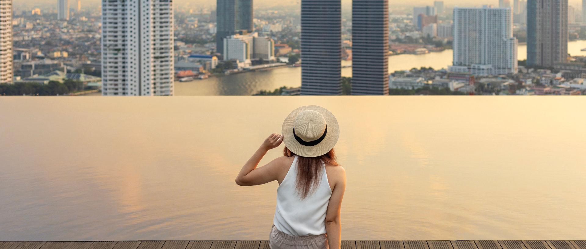 lady-sitting-infinity-pool-building-view