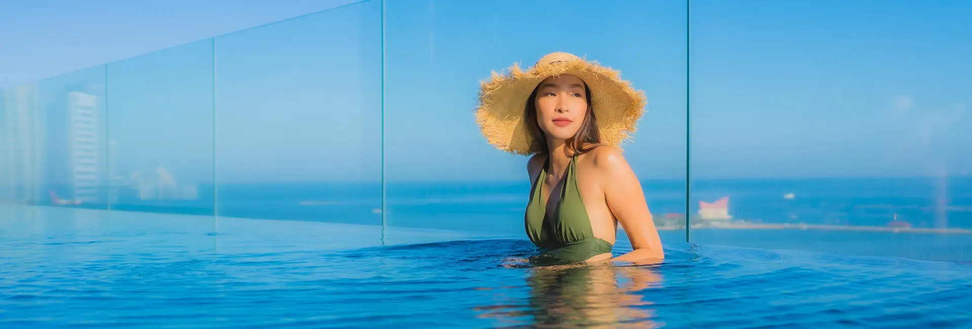 lady-wearing-green-swimsuit-hat-enjoying-pool