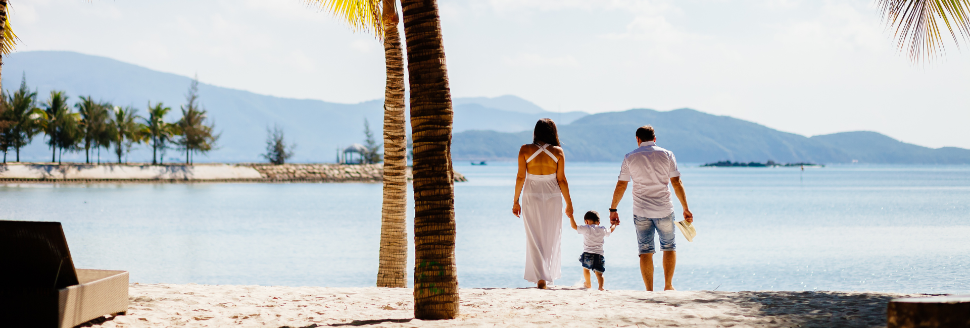 mother-father-son-family-walking-beach-hero-image