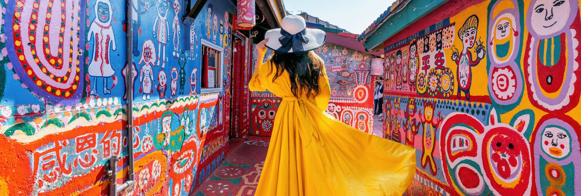 woman-in-yellow-in-colorful-alley