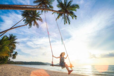 woman-swinging-in-the-beach