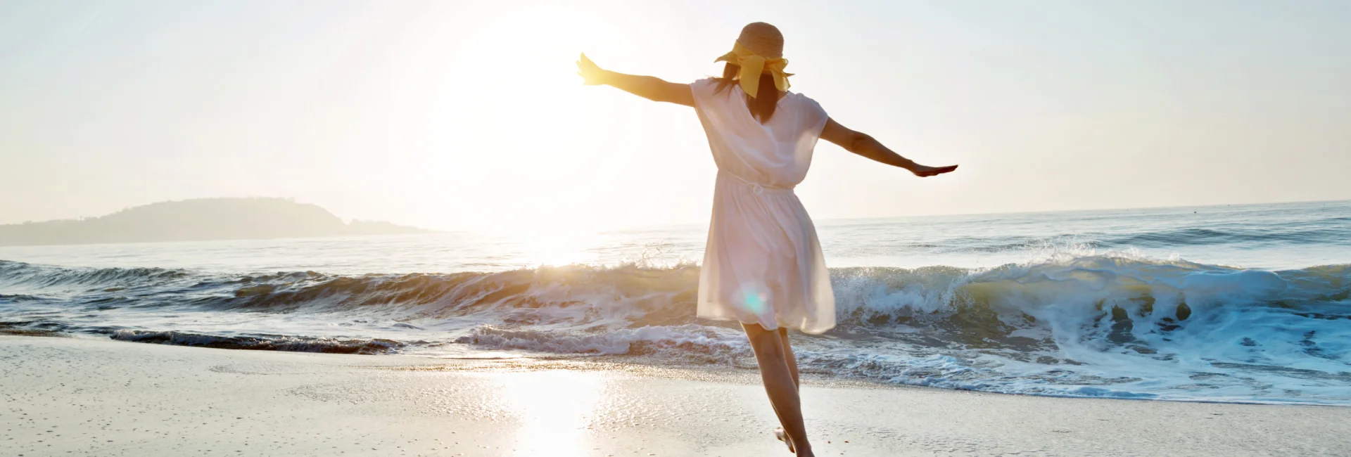 woman-wearing-white-dancing-at-beach-sunset-sunrise